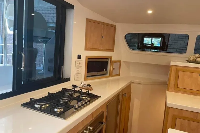 Lost Abbey Yacht Photos Pics Modern kitchen interior of 2021 Royal Cape Catamarans Majestic, featuring sleek design and appliances.