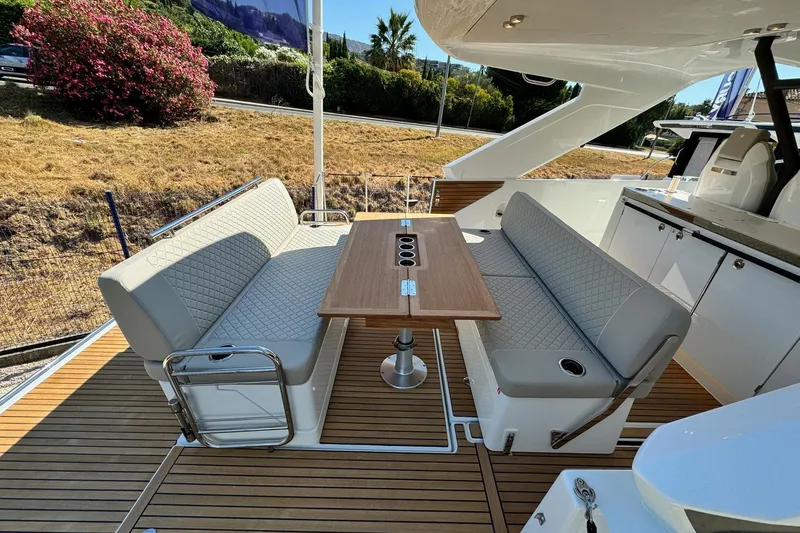  Yacht Photos Pics 2026 Jeanneau DB/37 IB yacht interior with elegant seating and wooden table.