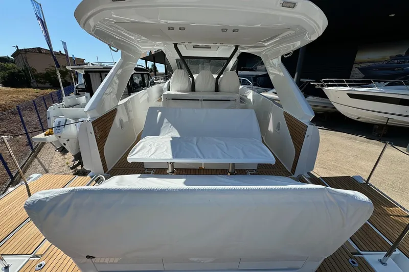  Yacht Photos Pics 2026 Jeanneau DB/37 IB boat interior with white seating and wooden deck.