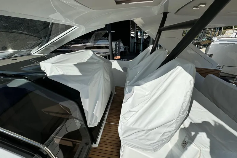  Yacht Photos Pics 2026 Jeanneau DB/37 IB yacht interior with covered seats and sleek design.