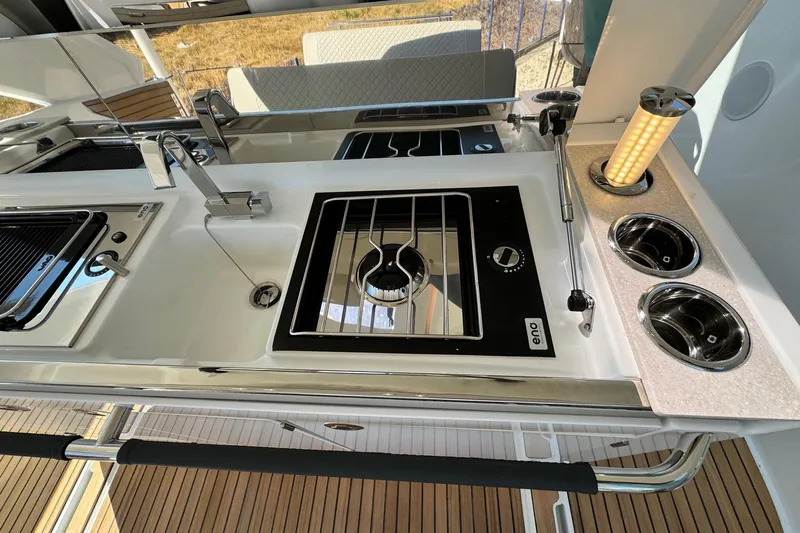  Yacht Photos Pics Modern kitchen area on 2026 Jeanneau DB/37 IB yacht with sleek appliances and fixtures.