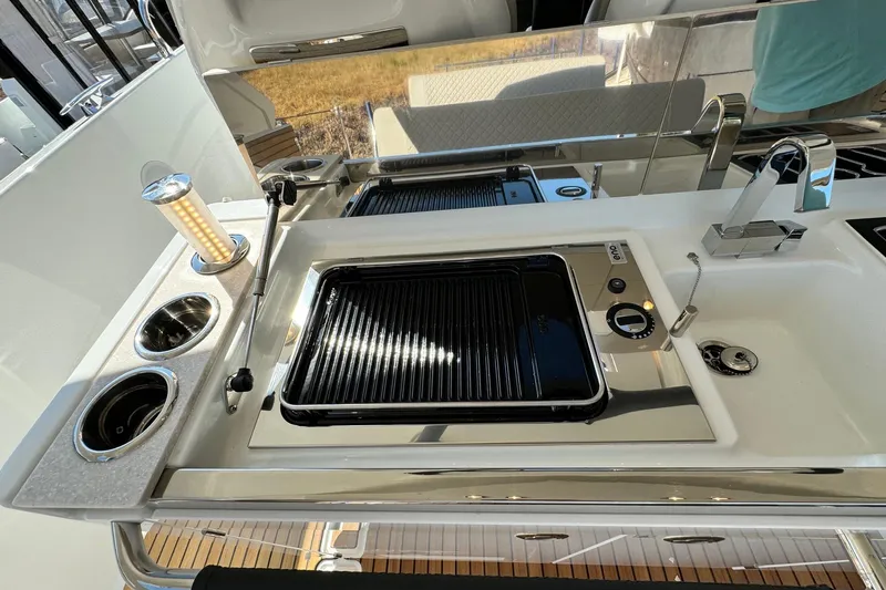  Yacht Photos Pics Outdoor kitchen on 2026 Jeanneau DB/37 IB yacht with grill and sink.