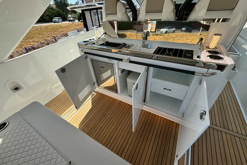  Yacht Photos Pics 2026 Jeanneau DB/37 IB yacht kitchen with open cabinets and modern appliances.