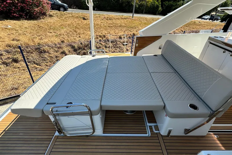  Yacht Photos Pics 2026 Jeanneau DB/37 IB boat with luxurious gray cushioned seating on teak deck.