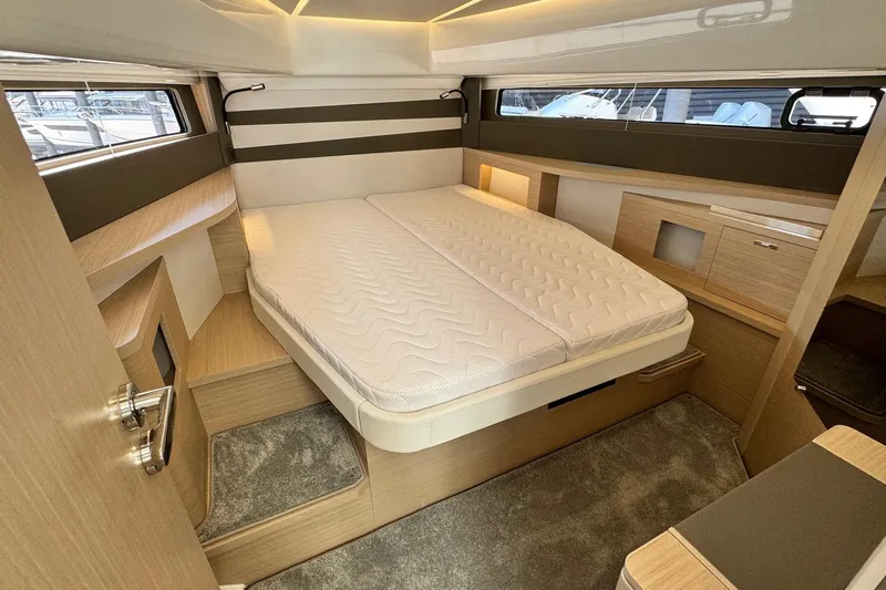  Yacht Photos Pics Luxurious cabin interior of 2026 Jeanneau DB/37 IB yacht with modern design and comfortable bedding.