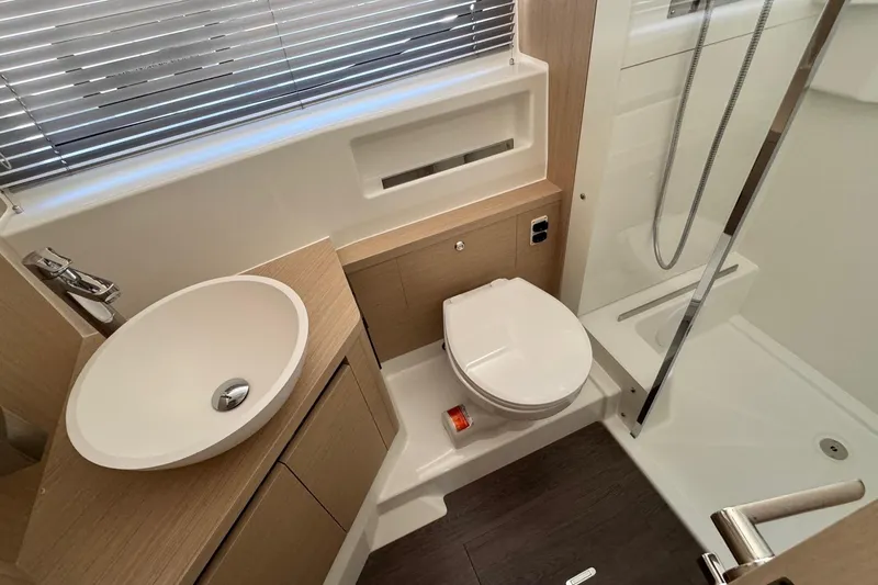  Yacht Photos Pics Modern bathroom in 2026 Jeanneau DB/37 IB yacht with sink, toilet, and shower.