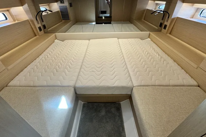  Yacht Photos Pics Luxurious interior cabin of 2026 Jeanneau DB/37 IB yacht with comfortable bedding.