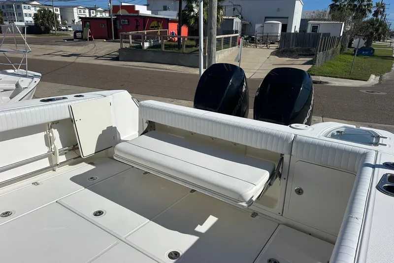  Yacht Photos Pics 2012 Boston Whaler 315 Conquest boat deck with seating and dual outboard engines.
