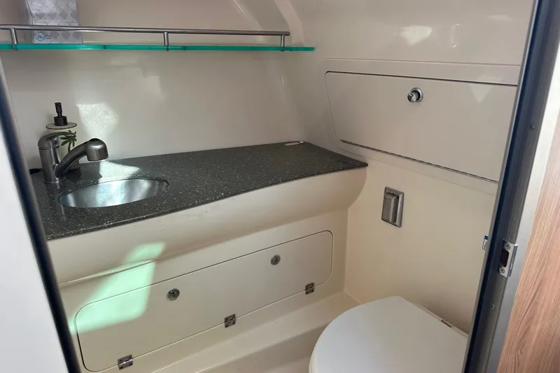  Yacht Photos Pics 2012 Boston Whaler 315 Conquest boat bathroom with sink, countertop, and storage.
