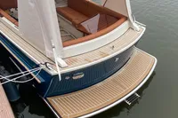 Luxury 2022 STATEMENT MARINE PTS 26 boat with elegant deck and seating area.
