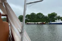 2022 STATEMENT MARINE PTS 26 boat interior with marina view, overcast sky.