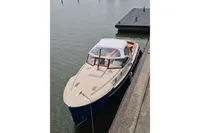 2022 STATEMENT MARINE PTS 26 boat docked on calm water.