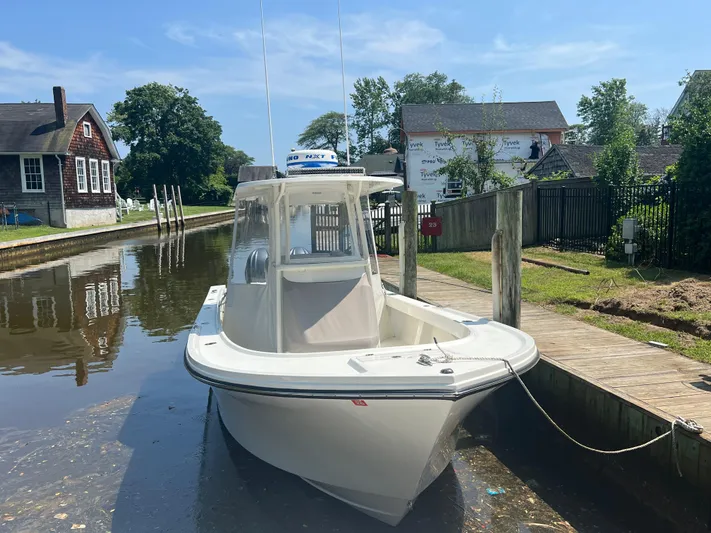  Yacht Photos Pics 2023 Parker 2801 Center Console boat docked in a serene canal setting.