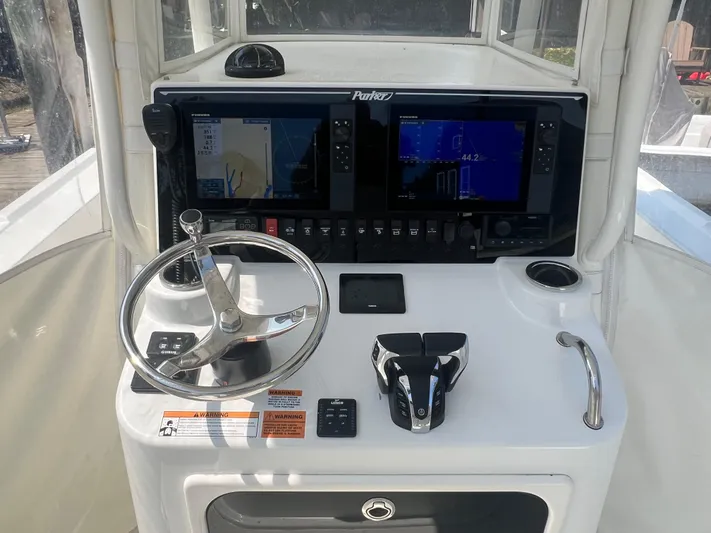  Yacht Photos Pics 2023 Parker 2801 Center Console boat dashboard with steering wheel and navigation screens.