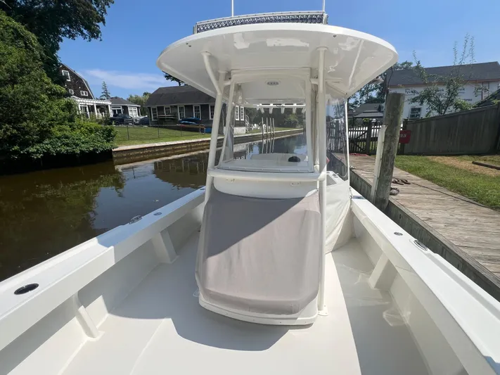  Yacht Photos Pics 2023 Parker 2801 Center Console boat docked by a canal, showcasing sleek design.