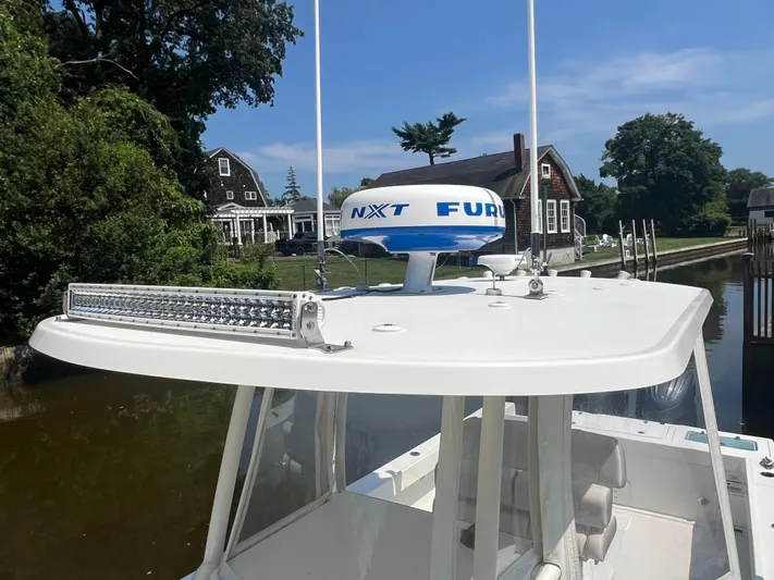  Yacht Photos Pics 2023 Parker 2801 Center Console boat with radar, docked near waterfront homes.