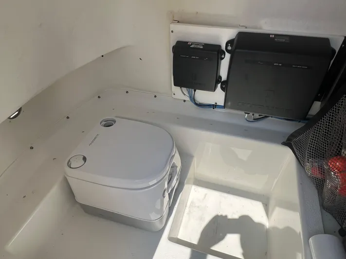  Yacht Photos Pics Interior of 2023 Parker 2801 Center Console boat with portable toilet and electronic equipment.