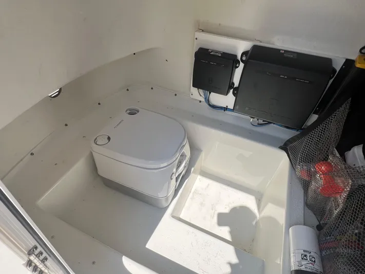  Yacht Photos Pics 2023 Parker 2801 Center Console boat interior with portable toilet and storage compartments.