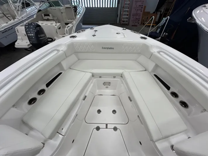  Yacht Photos Pics 2024 Everglades 285 Center Console boat interior with white seating and storage compartments.