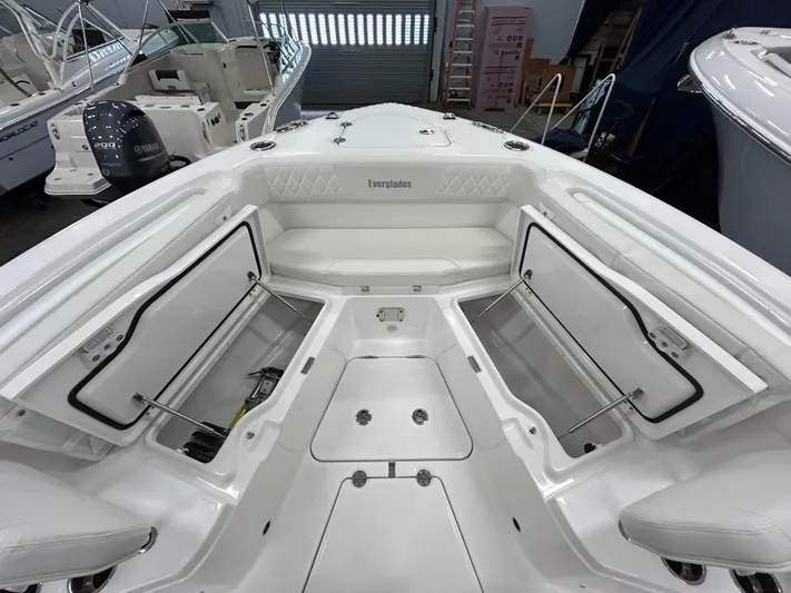  Yacht Photos Pics 2024 Everglades 285 Center Console boat with open storage compartments in a showroom.