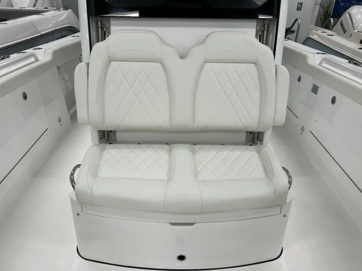  Yacht Photos Pics 2024 Everglades 285 Center Console boat with white cushioned seating.