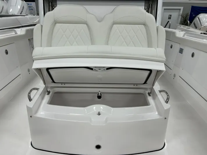  Yacht Photos Pics 2024 Everglades 285 Center Console boat with open storage compartment and cushioned seating.