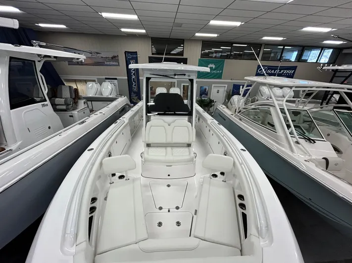  Yacht Photos Pics 2024 Everglades 285 Center Console boat in showroom, front seating view.