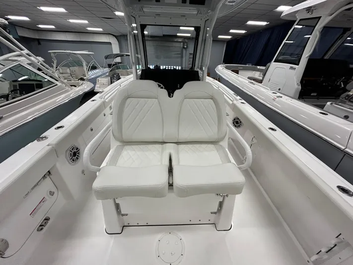  Yacht Photos Pics 2024 Everglades 285 Center Console boat interior with white cushioned seating.