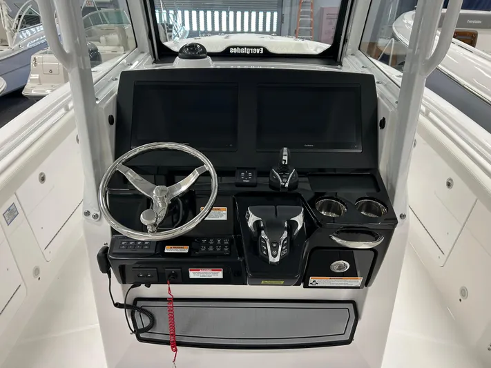  Yacht Photos Pics 2024 Everglades 285 Center Console boat dashboard with dual screens and steering wheel.