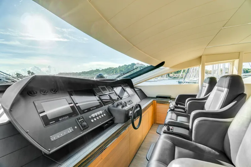  Yacht Photos Pics Luxurious helm of 2012 Pershing 92 yacht with modern navigation controls and leather seating.
