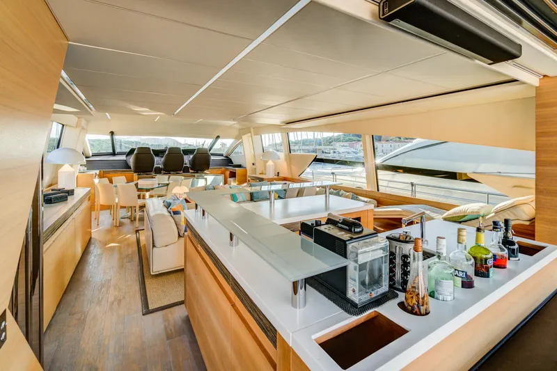  Yacht Photos Pics Luxurious interior of a 2012 Pershing 92 yacht with modern furnishings and a sleek bar area.