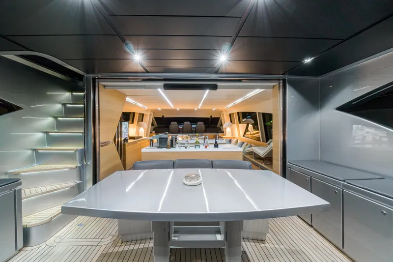  Yacht Photos Pics Luxurious interior of a 2012 Pershing 92 yacht with modern dining area and sleek design.