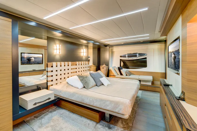  Yacht Photos Pics Luxurious bedroom interior on a 2012 Pershing 92 yacht, featuring modern design and elegant furnishings.