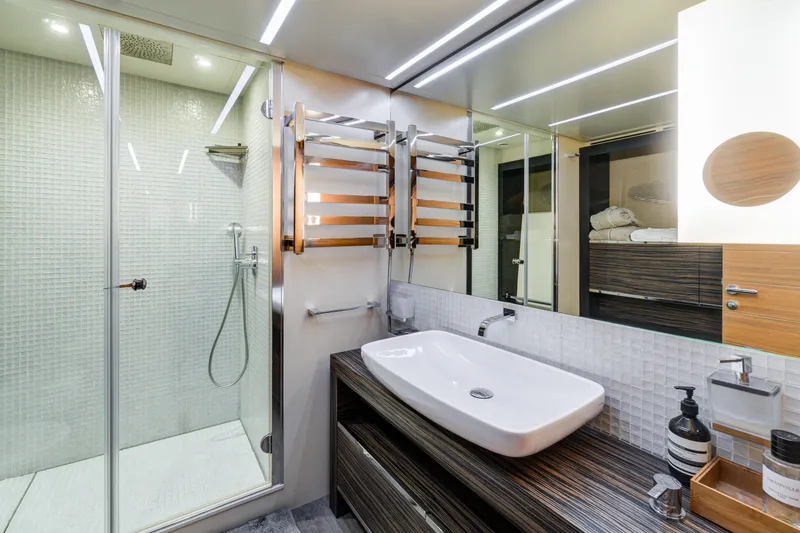  Yacht Photos Pics Luxurious bathroom in 2012 Pershing 92 yacht with modern fixtures and glass shower.