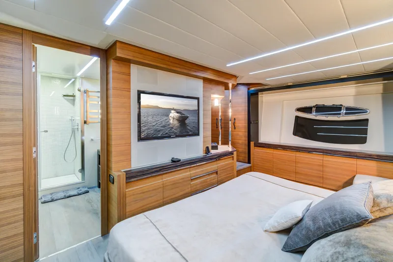  Yacht Photos Pics Luxurious 2012 Pershing 92 yacht bedroom with modern wood paneling and ensuite bathroom.