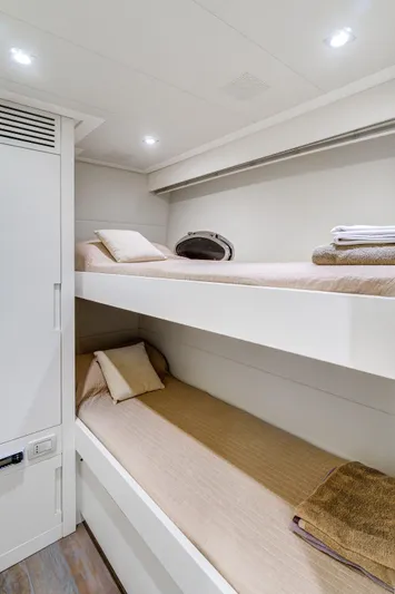  Yacht Photos Pics Bunk beds in a 2012 Pershing 92 yacht cabin, featuring modern design and cozy bedding.