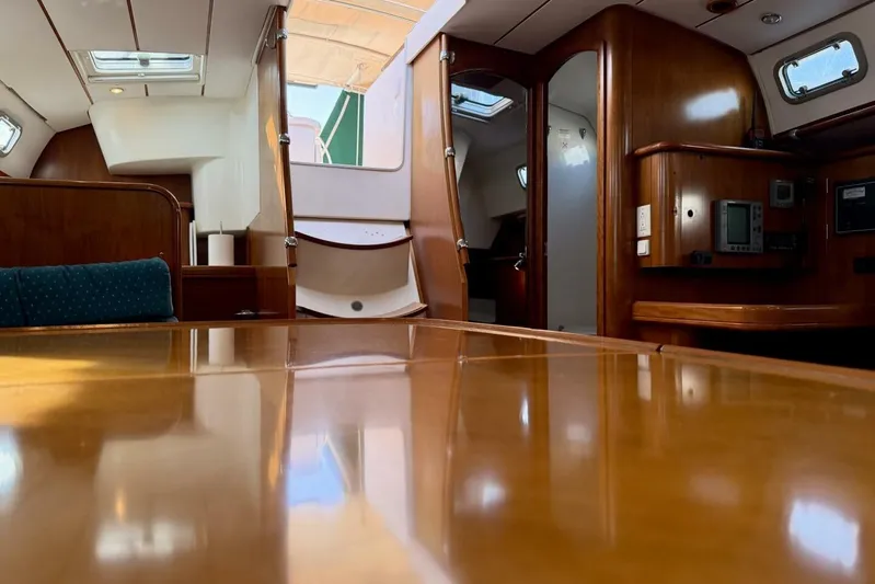 Eda Yacht Photos Pics Interior of 2000 Beneteau Oceanis 461 yacht, featuring polished wood and navigation equipment.