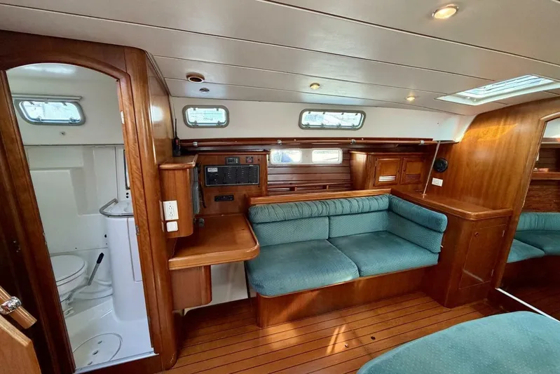 Eda Yacht Photos Pics Interior of 2000 Beneteau Oceanis 461 yacht with wood finish and seating area.