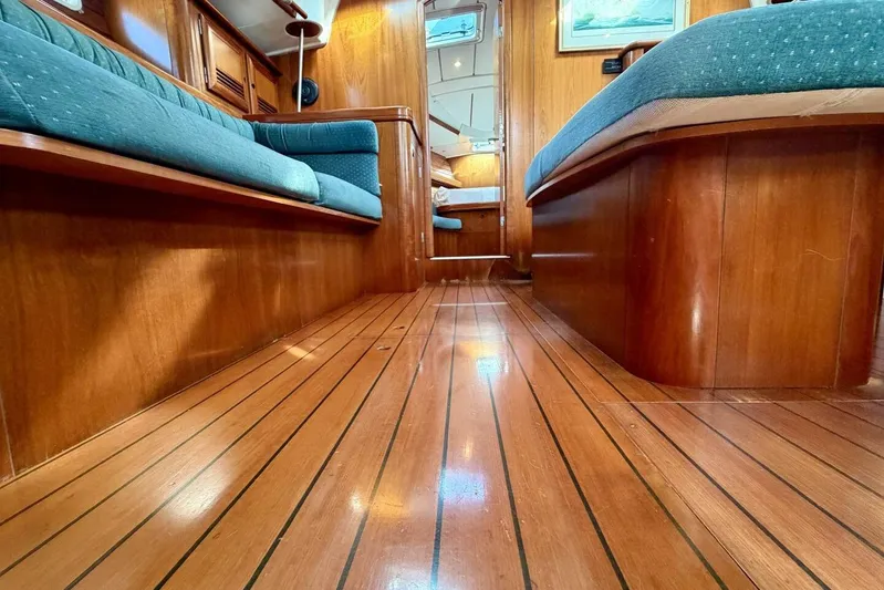 Eda Yacht Photos Pics Interior of 2000 Beneteau Oceanis 461 yacht with polished wood flooring and blue seating.