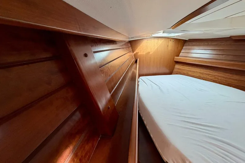 Eda Yacht Photos Pics Interior cabin of 2000 Beneteau Oceanis 461 with wooden paneling and bed.