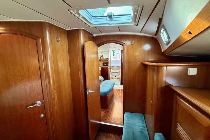 Eda Yacht Photos Pics Interior of 2000 Beneteau Oceanis 461 yacht with wooden finish and seating area.