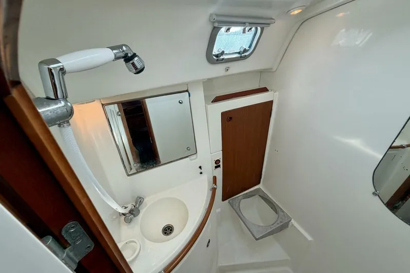 Eda Yacht Photos Pics Bathroom interior of 2000 Beneteau Oceanis 461 yacht with sink and mirror.
