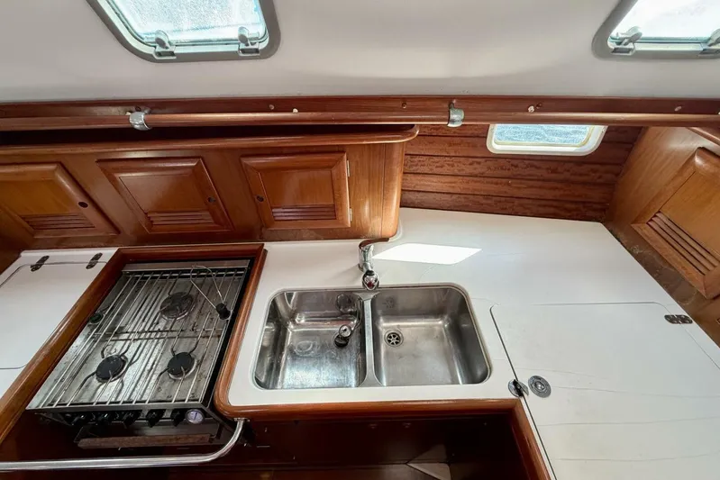 Eda Yacht Photos Pics Beneteau Oceanis 461 yacht kitchen with stove, sink, and wooden cabinets, 2000 model.