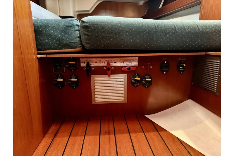 Eda Yacht Photos Pics Interior view of a 2000 Beneteau Oceanis 461 sailboat showing electrical panel and wooden flooring.