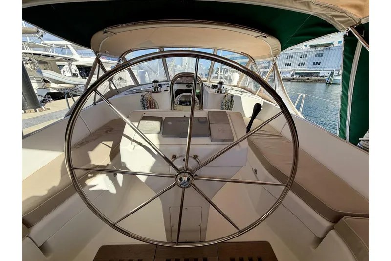 Eda Yacht Photos Pics Steering wheel of 2000 Beneteau Oceanis 461 sailboat in marina setting.