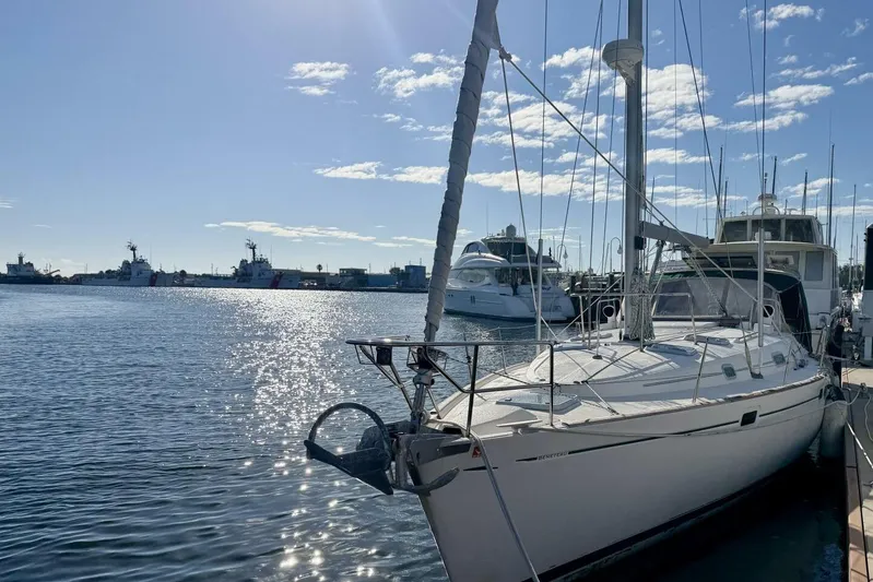 Eda Yacht Photos Pics 2000 Beneteau Oceanis 461 sailboat docked in sunny marina with clear skies.