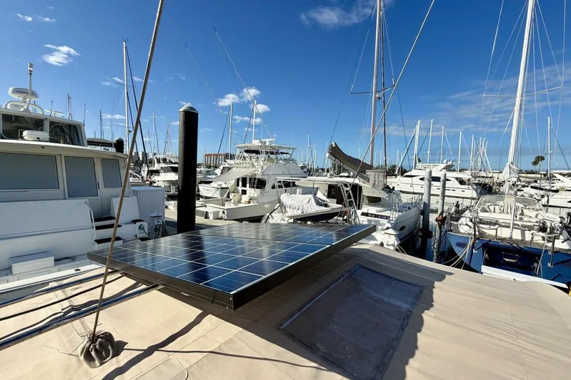 Eda Yacht Photos Pics Beneteau Oceanis 461 sailboat with solar panels docked in a marina, 2000 model.