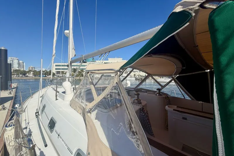Eda Yacht Photos Pics 2000 Beneteau Oceanis 461 sailboat docked at marina, featuring green canopy and clear skies.