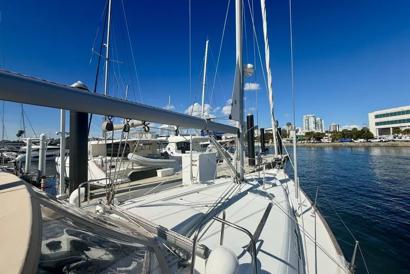 Eda Yacht Photos Pics 2000 Beneteau Oceanis 461 sailboat docked at marina with city skyline.