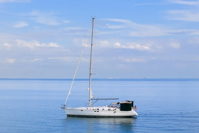 Eda Yacht Photos Pics Sailboat Beneteau Oceanis 461, 2000 model, cruising on calm blue waters under a clear sky.